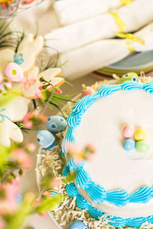 Dessert table set with cake and cupcakes for Easter brunch.の写真素材