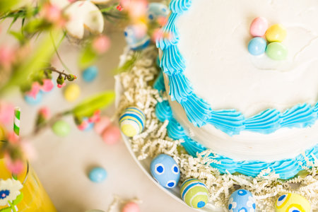 Dessert table set with cake and cupcakes for Easter brunch.