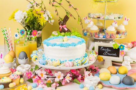 Dessert table set with cake and cupcakes for Easter brunch.の写真素材