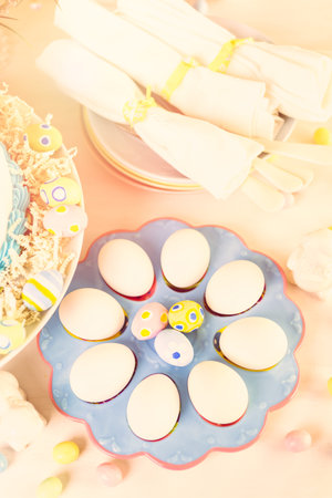 Dessert table set with cake and cupcakes for Easter brunch.