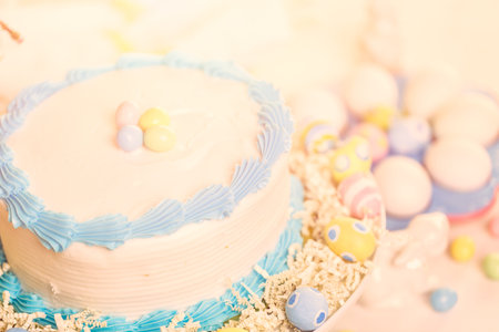 Dessert table set with cake and cupcakes for Easter brunch.