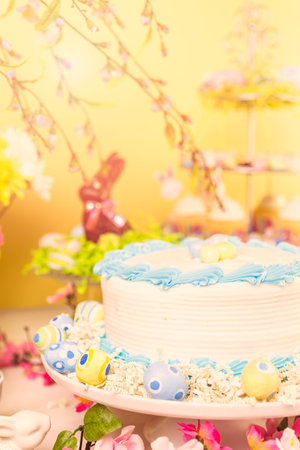 Dessert table set with cake and cupcakes for Easter brunch.