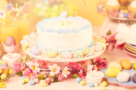 Dessert table set with cake and cupcakes for Easter brunch.の写真素材
