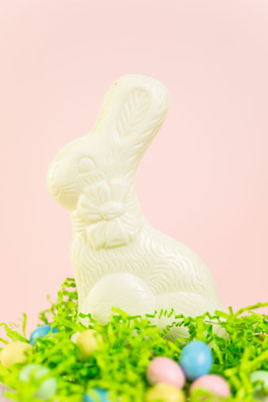 Chocolate Easter bynny with chocolate Easter candies on stand.