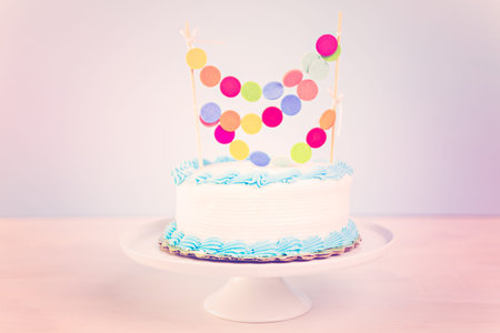 Simple white Birthday cake with cake garland.