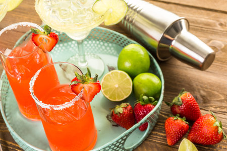 Classic lime and strawberry margaritas on the rocks.の写真素材