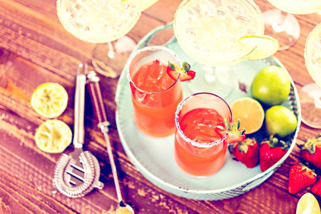 Classic lime and strawberry margaritas on the rocks.の写真素材