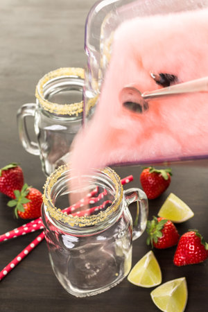 Frozen strawberry margarita cocktail in drinking mason jar.の写真素材