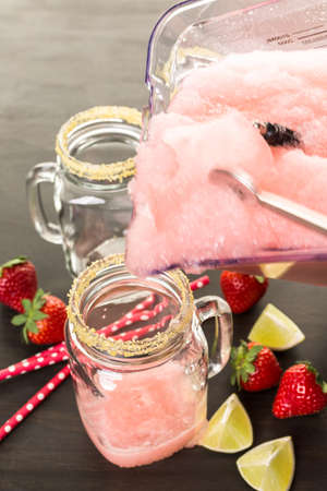 Frozen strawberry margarita cocktail in drinking mason jar.の写真素材