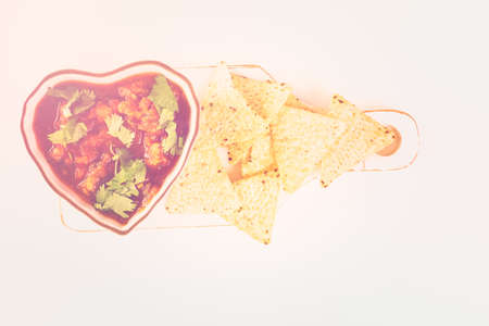 Fresh salsa in white bowl with chips.の写真素材