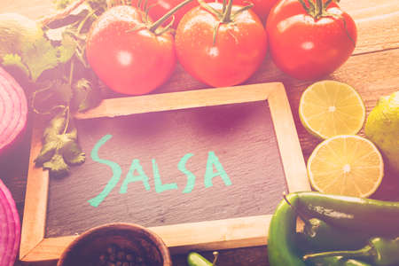 Fresh salsa in white bowl with ingredients.の写真素材