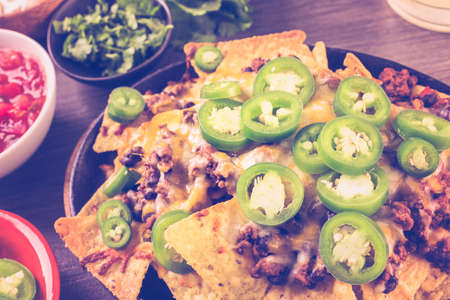 Claasic nachos with ground beef and fresh jalapeno chile peppers.の写真素材