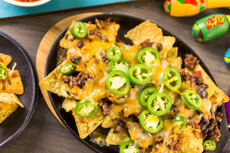 Claasic nachos with ground beef and fresh jalapeno chile peppers.の写真素材