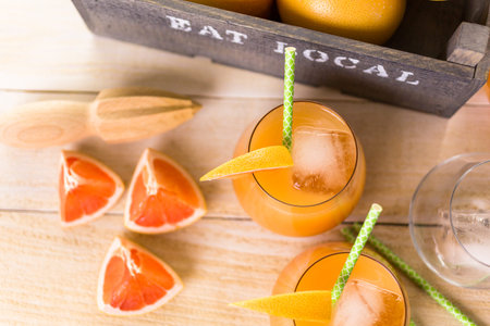 Organic ryby red grapefruit juice in small glass with ice.