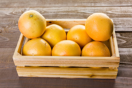 Fresh ryby red grapefruits in wood crate.の写真素材