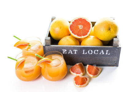 Organic ryby red grapefruit juice in small glass with ice.の写真素材