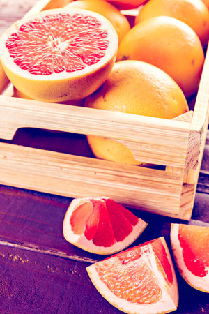 Fresh ruby red grapefruits in wood crate.