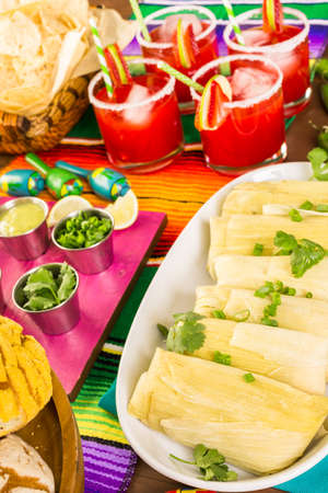 Party table with tamales, strawberry margartisa and pan dulche bread.の写真素材