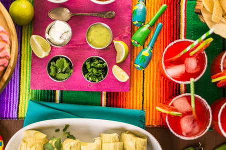 Party table with tamales, strawberry margartisa and pan dulche bread.の写真素材