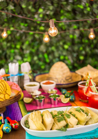 Party table with tamales, strawberry margartisa and pan dulche bread.の写真素材