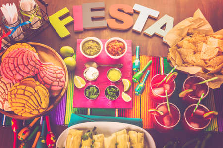 Party table with tamales, strawberry margartisa and pan dulche bread.の写真素材