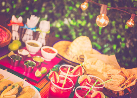Party table with tamales, strawberry margartisa and pan dulche bread.の写真素材