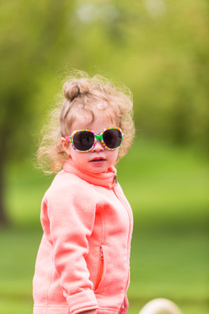 Toddler playing at the playground in urban park.の写真素材