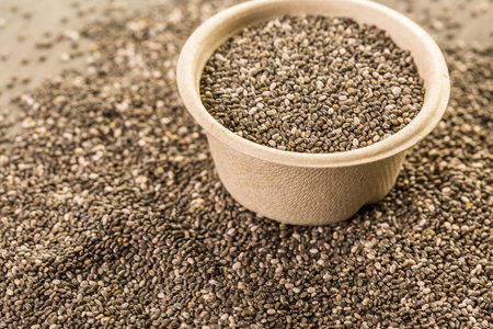 Healthy Chia seeds in a paper bowl close-up.