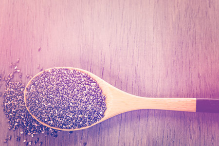 Healthy Chia seeds in a wooden spoon on the table close-up.の写真素材