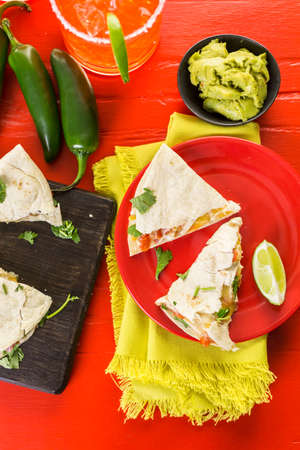 Sliced quesadilla filled with cheese, chicken and pico de gallo.の写真素材