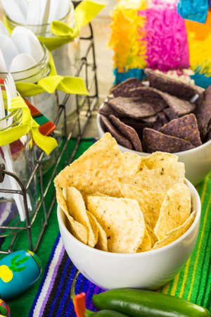 Fiesta party buffet table with tortilla chips and other traditional Mexican food.の写真素材