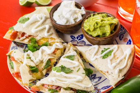 Sliced quesadilla filled with cheese, chicken and pico de gallo.の写真素材