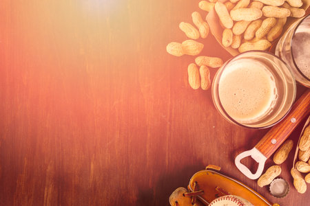 Close up of old worn baseball equipment on a wooden background.の写真素材