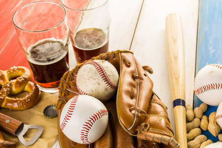 Close up of old worn baseball equipment on a wooden background.の写真素材