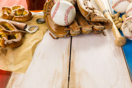 Close up of old worn baseball equipment on a wooden background.の写真素材