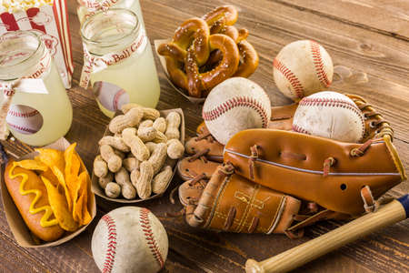 Game day traditional snacks included corndogs and salted peanuts on a wood board.の写真素材