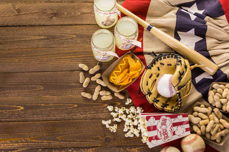 Game day traditional snacks included corndogs and salted peanuts on a wood board.の写真素材