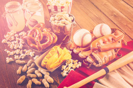 Game day traditional snacks included corndogs and salted peanuts on a wood board.の写真素材
