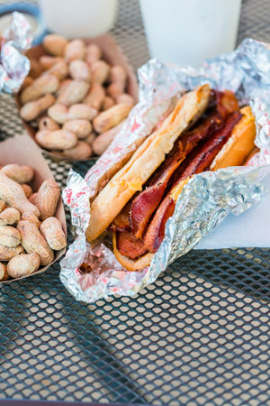 Street food lunch with peanuts, hotdog, and hamburger.の写真素材