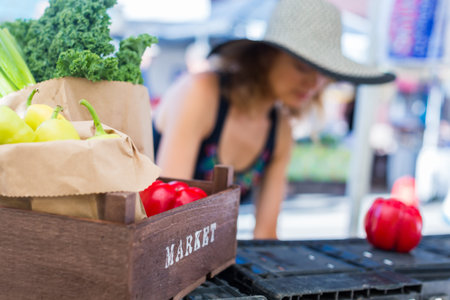 Young woman shopping at the local Farmers market.