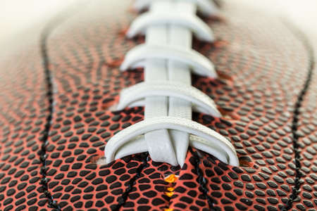 Close up of brown leather and white laces of American Football.の写真素材