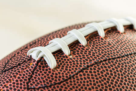 Close up of brown leather and white laces of American Football.の写真素材