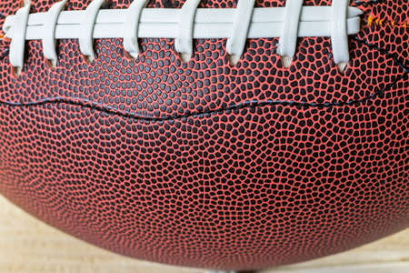 Close up of brown leather and white laces of American Football.の写真素材