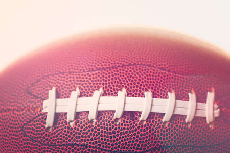 Close up of brown leather and white laces of American Football.の写真素材