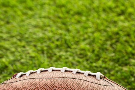 American Football Close up on on green grass.の写真素材