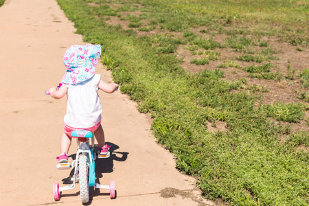 Toddler learning how to ride her first bike.の写真素材