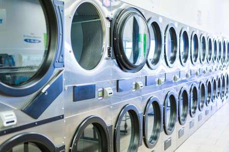 Industrial washing machines in a public laundryの写真素材