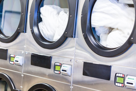 Industrial washing machines in a public laundry.の写真素材