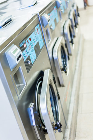 Industrial washing machines in a public laundry.の写真素材