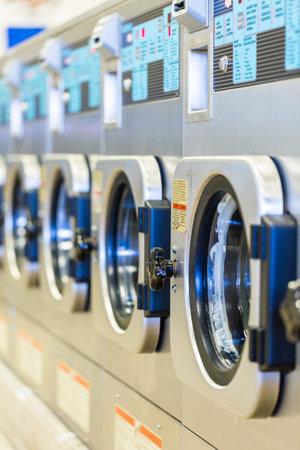 Industrial washing machines in a public laundry.の写真素材